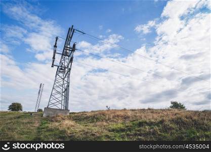 Large pylons with electrical wires over a dry field