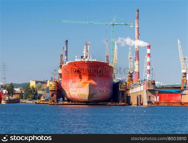 Large red tanker in dry dock port of Gdansk.. Gdansk. Sea port.