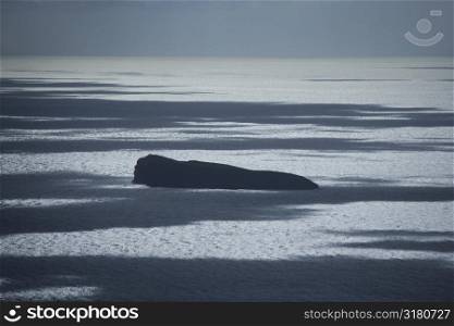 Large rock island in Pacific ocean.