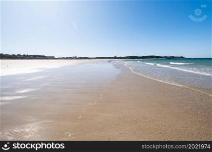 "Large sandy beach in the town of "Sables d&rsquo;or les pins" in Brittany at low tide in summer.. Large sandy beach in the town of "Sables d&rsquo;or les pins" in Brittany at low tide in summer"
