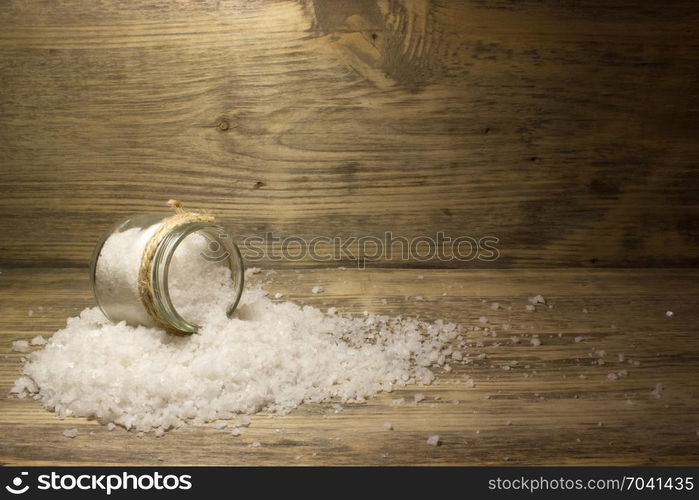 Large sea salt on wooden background