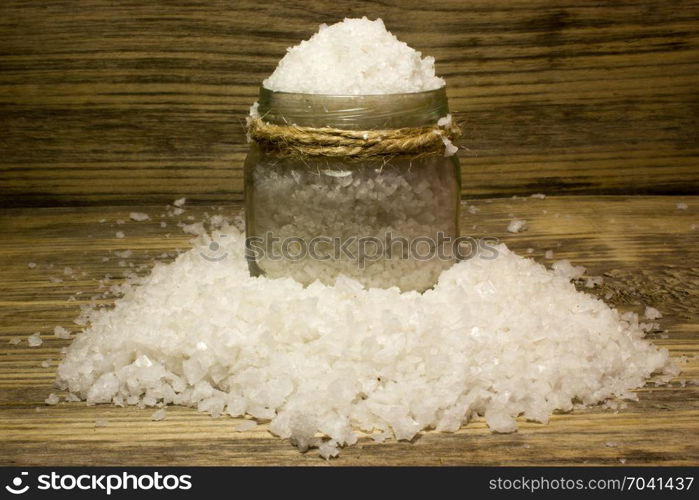 Large sea salt on wooden background