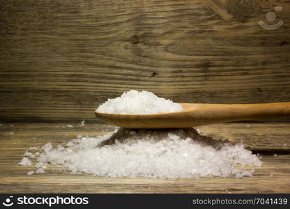 Large sea salt on wooden background