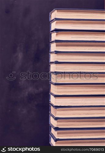 large stack of books in a blue cover, copy space