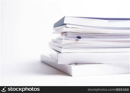 large stack of different broshures and books isolated on a white background