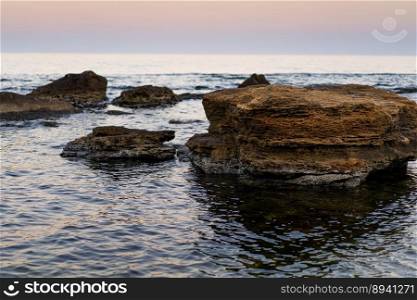 Large stone cliffs on the shore of sea