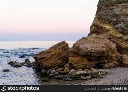Large stone cliffs on the shore of sea