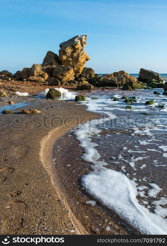 Large stones by the sea near the village of Fontanka, Odessa region, Ukraine. A scattering of large stones by the sea