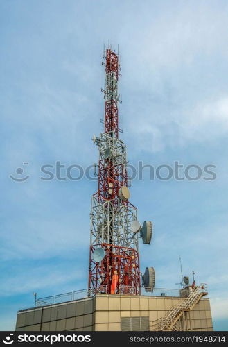 Large telecommunication tower against sky and clouds in background . Internet network connection concept .. Large telecommunication tower against sky and clouds in background