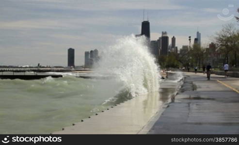 Large waves splashing against the Lake Shore Path along Lake Michigan in Chicago