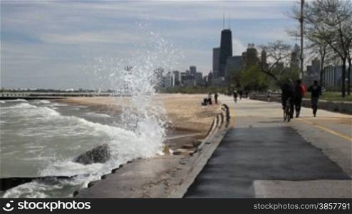 Large waves splashing against the Lake Shore Path along Lake Michigan in Chicago