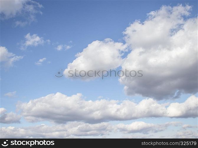 Large white air clouds in the blue sky.