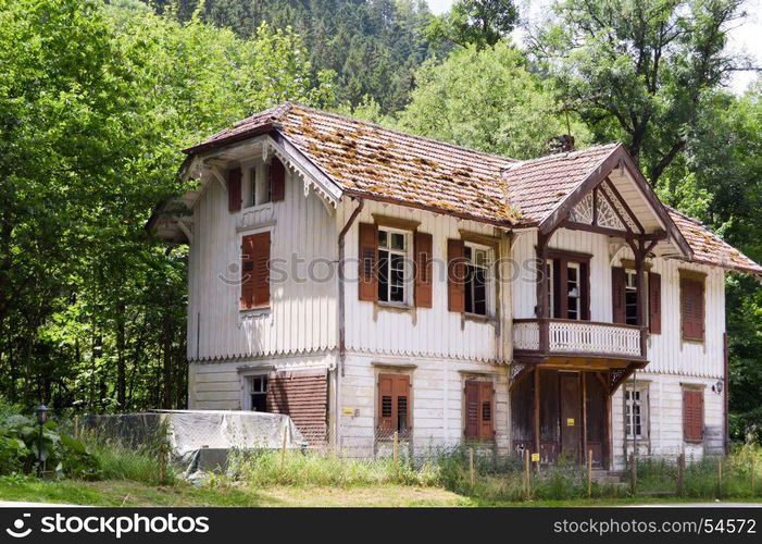 Large white house with two porticos . Large white house with two porticos and a beautiful flower garden