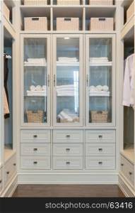large white walk-in closet with shelves at home