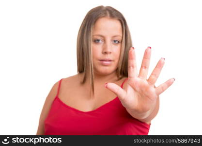 Large woman signaling stop to junk food in order to start a diet