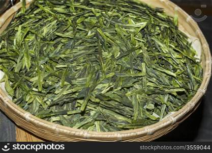 Large Wooden dish with dry Green Tea leaves