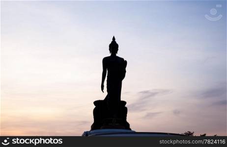 Larger Buddha. In the evening. The black silhouette of a Buddha statue.