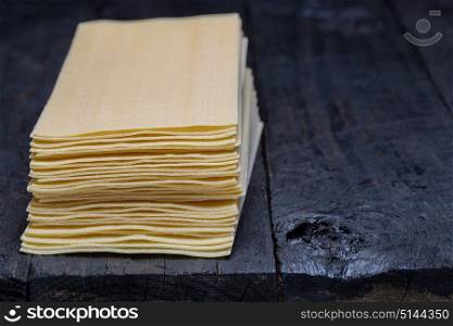 Lasagna noodle on dark rustic wood.. Lasagna noodle on dark rustic wood