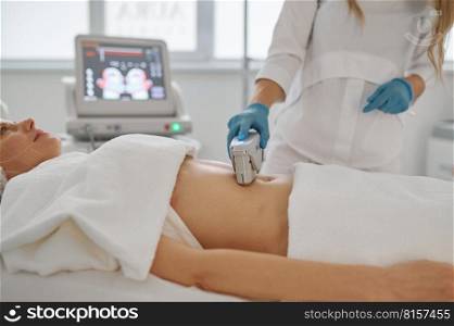 Laser epilation and cosmetology in beauty salon. Closeup woman cosmetologist removing hair from client belly. Laser epilation and cosmetology in beauty salon