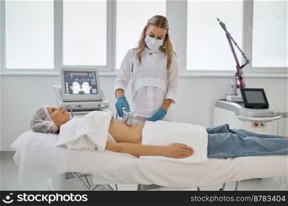 Laser epilation and cosmetology in beauty salon. Woman cosmetologist removing hair from client belly. Laser epilation and cosmetology in beauty salon