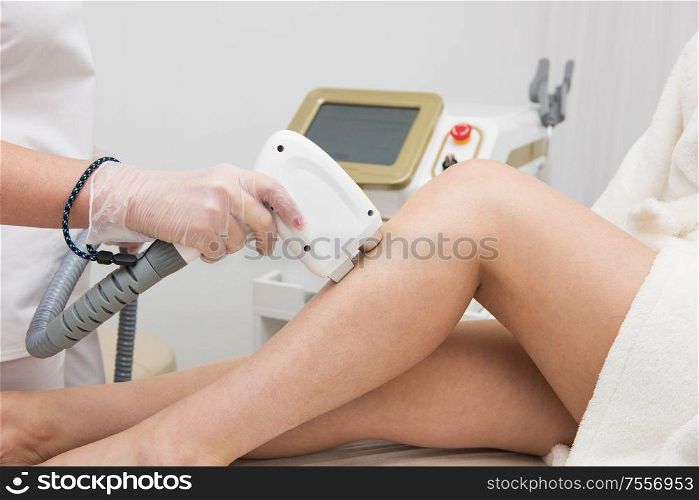 Laser epilation of legs, hair removal cosmetology procedure. Health and beauty concept.. Laser epilation of legs