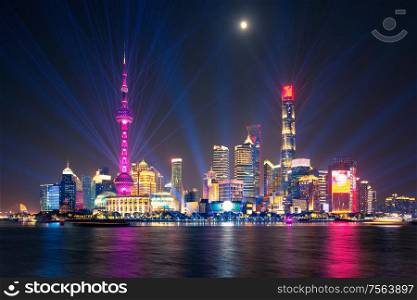 laser show over illuminated Lujiazui skyline and Huangpu river at night, Shanghai, China. laser show over Lujiazui skyline and Huangpu river, Shanghai, China