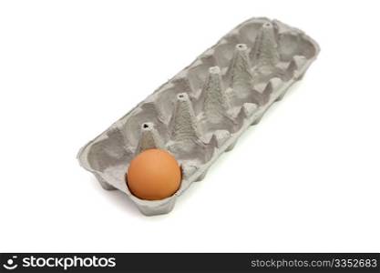 Last remaining brown egg in a paper box isolated