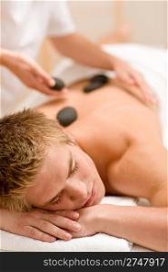 Lastone therapy - man at luxury massage in spa center