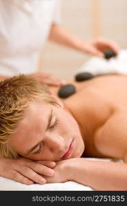 Lastone therapy - man at luxury massage in spa center