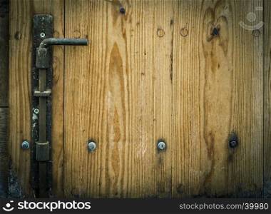 Latch and wooden planks, part of an aged door from a german warehouse, with copy space on the right side for your text.