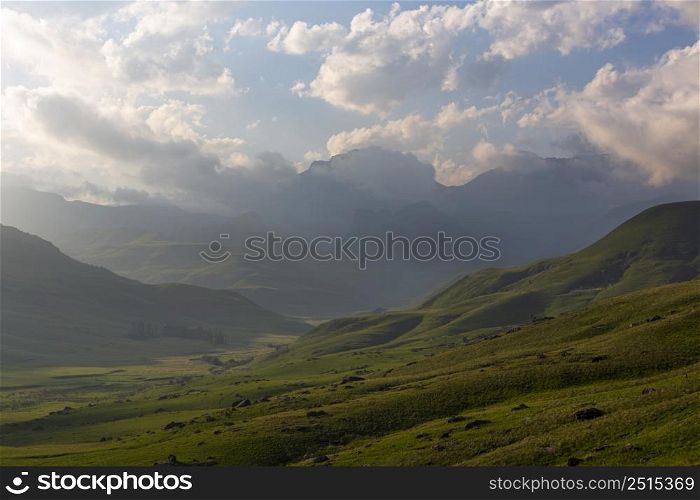 Late afternoon clouds over green valley Drakensberg South Africa