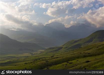 Late afternoon clouds over green valley Drakensberg South Africa