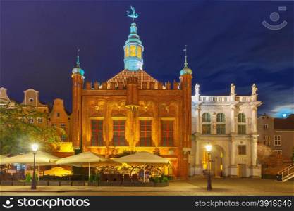 Late-gothic building of Brotherhood of St George and west side of Golden Gate in Gdansk Old Town at night, Poland