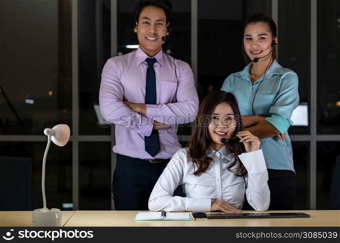 Late Night Environment, Portrait of friendly Call centre operator team with headsets in a call center customer service and technical support. Using for 24 Hr. Call center Concept.