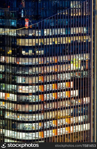 Late Working urban concept, window facade of business center office skyscraper and skylines building at night in bangkok downtown thailand