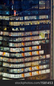 Late Working urban concept, window facade of business center office skyscraper and skylines building at night in bangkok downtown thailand