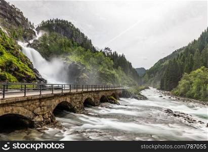 Latefoss waterfalls streams under the stone bridge archs, Odda, Hordaland county, Norway