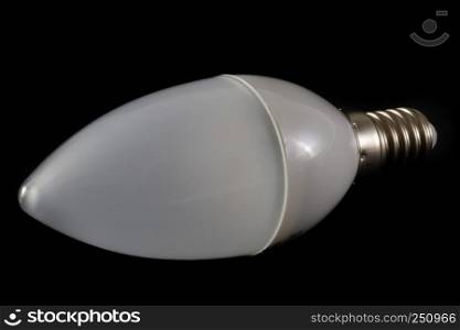 Latest modern LED light bulb in candle shape on black background demonstrating modern eco energy saving technology