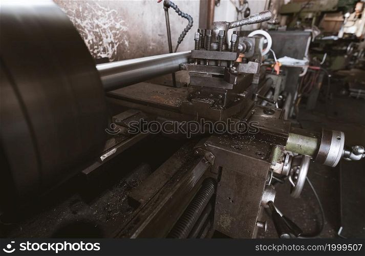 Lathe machine working in factory. Lathe turning machine for metalwork. Heavy machinery manufacturing. Machine for milling metal. Background for safety in industrial workplace concept. Steel industry.