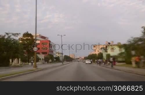 Latin American cities and travel, time-lapse of the city of La Habana, Cuba at sunset with cars on the road, people and street traffic