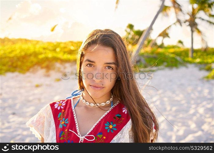 Latin beautiful girl happy in Caribbean beach sunset with embroidery dress portrait