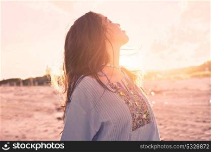 Latin beautiful girl happy in Caribbean beach sunset with embroidery dress portrait