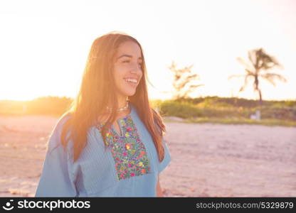 Latin beautiful girl happy in Caribbean beach sunset with embroidery dress portrait