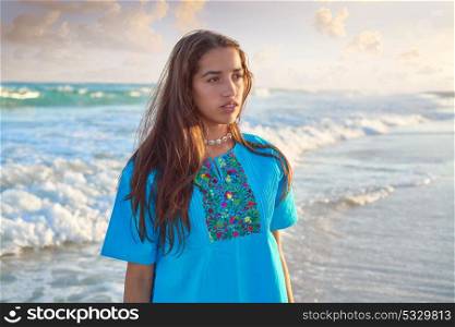 Latin beautiful girl in Caribbean beach sunset with embroidery dress