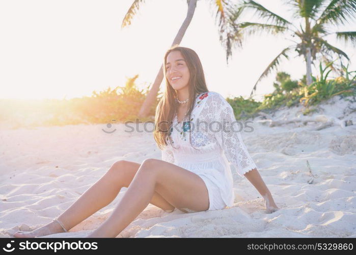 Latin beautiful girl sunset in Caribbean beach sand sitting relaxed