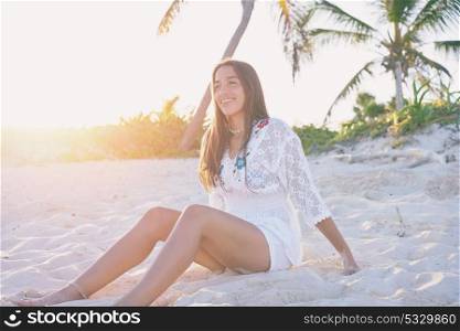 Latin beautiful girl sunset in Caribbean beach sand sitting relaxed