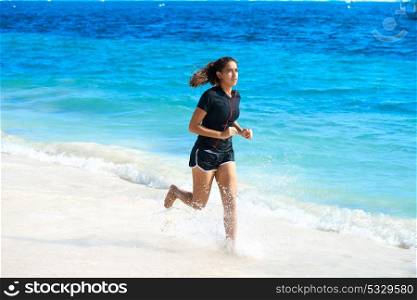 Latin girl running in caribbean shore beach of Mayan Riviera of Mexico