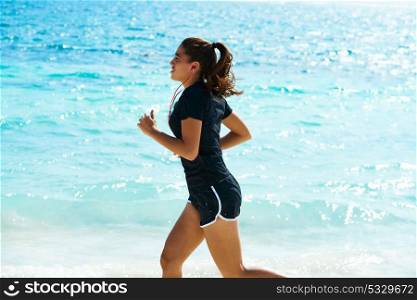 Latin girl running in caribbean shore beach of Mayan Riviera of Mexico