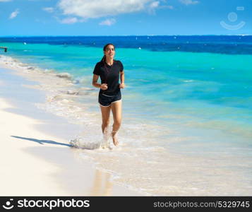 Latin girl running in caribbean shore beach of Mayan Riviera of Mexico