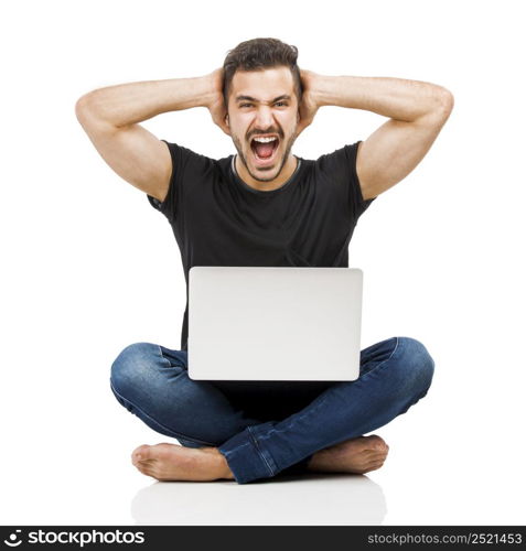 Latin man sitting on the floor and working with a laptop with the hands on the head